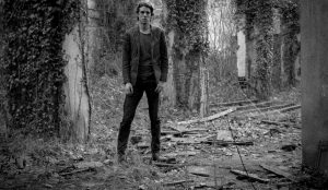 Photo of Psychedelic Indie Rock Music Artist Samuel Christen, full body photo with background ruins
